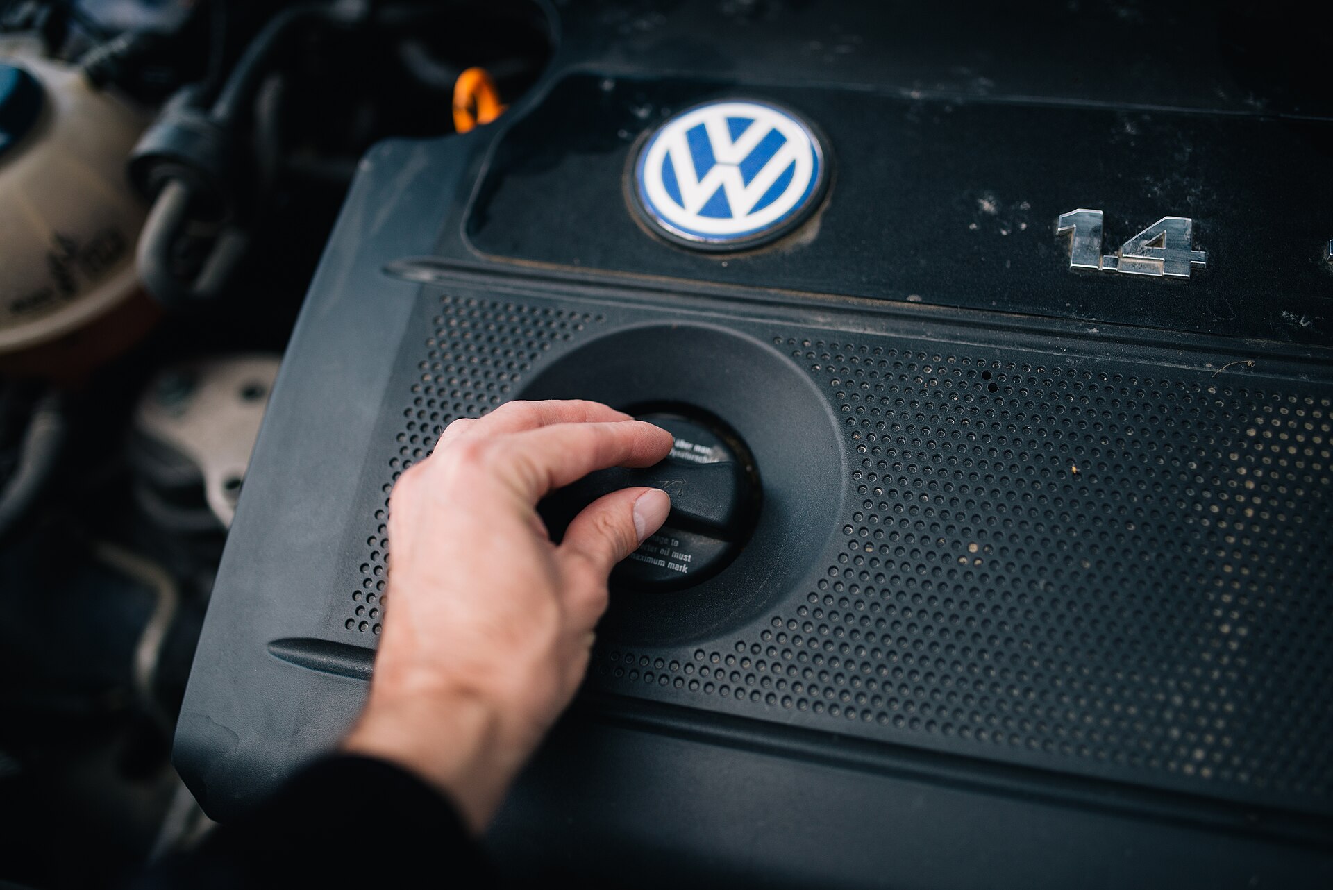 A technician checking the engine of a vehicle